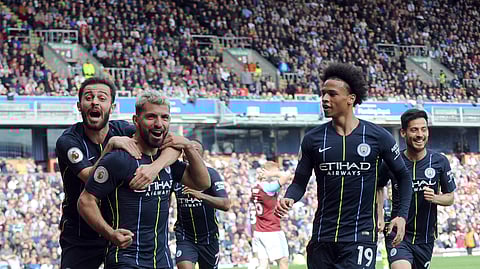 Manchester City’s Sergio Aguero, second left, celebrates with teammates after scoring his side’s opening goal during the English Premier League soccer match between Burnley and Manchester City at Turf Moor in Burnley, England, Sunday, April 28, 2019. (AP Photo/Rui Vieira)