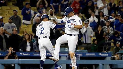 Los Angeles Dodgers’ Joc Pederson, right, celebrates with third base coach Dino Ebel (12) after hitting a solo home run during the ninth inning of a baseball game against the New York Mets Wednesday, May 29, 2019, in Los Angeles. (AP Photo/Marcio Jose Sanchez)