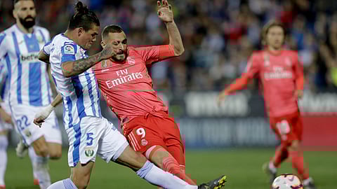 Real Madrid’s Karim Benzema duels for the ball against Leganes’ Jonathan Cristian, left, Silva during a Spanish La Liga soccer match on April 15, 2019. 