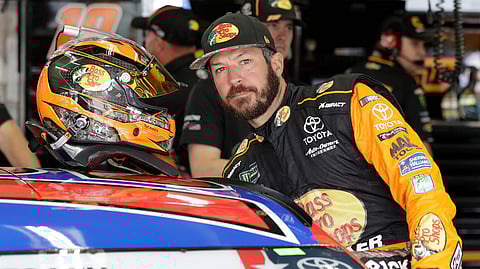 Martin Truex Jr. climbs into his car before practice on May 23 (Chuck Burton)