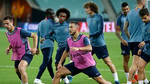 Chelsea’s Eden Hazard, center, stretches during a soccer training session at the Olympic stadium in Baku, Azerbaijan, Tuesday May 28, 2019. English Premier League teams Arsenal and Chelsea are preparing for the Europa League Final soccer match that takes place in Baku on Wednesday night. (AP Photo/Darko Bandic)