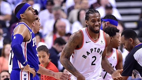 Toronto Raptors forward Kawhi Leonard smiles as Philadelphia 76ers forward Tobias Harris looks at the scoreboard during the first half of Game 5 of the NBA basketball second-round playoff series on May 7, 2019.