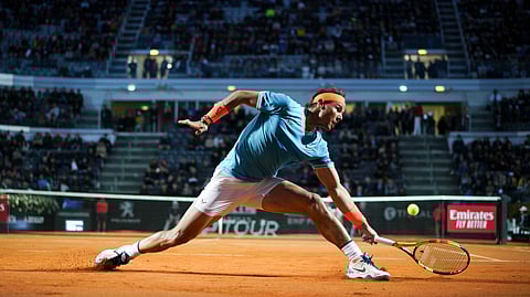 Rafael Nadal of Spain returns the ball to Nikoloz Basilashvili of Georgia at the Italian Open tennis tournament, in Rome, Thursday, May 16, 2019. (AP Photo/Andrew Medichini)