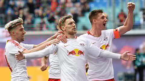 FILE - In this April 27, 2019 file photo, Leipzig’s Emil Forsberg, 2nd right, celebrates after scoring a goal. The contrast between his club and Bayern Munichcould hardly be greater:  Fifty-four major titles compared to none, 119 years of existence against 10, some 290,000 club members versus 17. The clubs meet in the German Cup final on Saturday, when Leipzig will bid for its first ever title and Bayern will hope to bring a happy end to a testing season with another domestic double. (AP Photo/Jens Meyer)