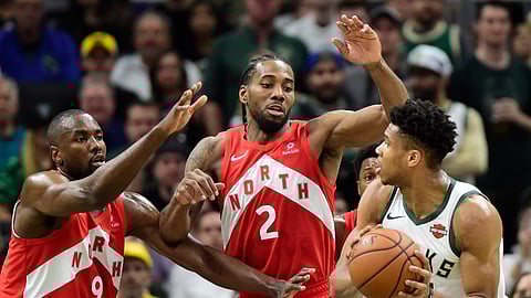 Raptors Serge Ibaka (9) and Kawhi Leonard double team Bucks’ Giannis Antetokounmpo in Game 5 on May 23 (Frank Gunn/The Canadian Press)