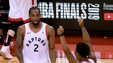 Toronto Raptors’ Kawhi Leonard (2) and Kyle Lowry (7) react during the second half of Game 6 of the team’s NBA basketball playoffs Eastern Conference finals against the Milwaukee Bucks on Saturday, May 25, 2019, in Toronto. The Raptors won 100-94 to advance to the NBA Finals. (Frank Gunn/The Canadian Press via AP)