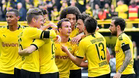 Dortmund’s Mario Goetze, center, celebrates after scoring his side’s third goal during the German Bundesliga soccer match between Borussia Dortmund and Fortuna Duesseldorf in Dortmund, Germany, Saturday, May 11, 2019. (AP Photo/Martin Meissner)