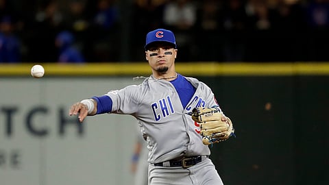 Chicago Cubs shortstop Javier Baez throws to first after forcing out Seattle Mariners’ Mitch Haniger at second base during the sixth inning of a baseball game on April 30, 2019.