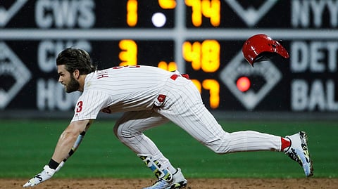 Philadelphia Phillies’ Bryce Harper dives to second base after hitting a double with two runs batted in off of St. Louis Cardinals starting pitcher Adam Wainwright during the third inning of a baseball game on May 28, 2019.