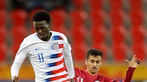United States’ Tim Weah, front, duels for the ball with Qatar’s Abdulla Nasser during the Group D U20 World Cup soccer match between USA and Qatar, in Tychy, Poland, Thursday, May 30, 2019. (AP Photo/Sergei Grits)