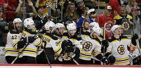 Bruins on the bench celebrate as they advance to the Stanley Cup Finals by beating the Hurricanes (Gerry Broome)