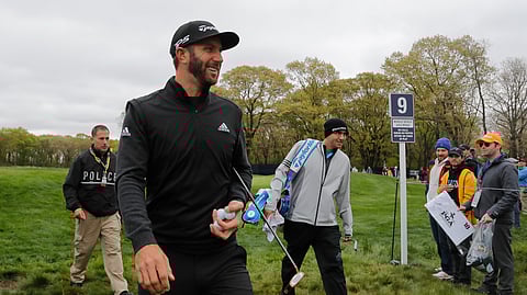 Dustin Johnson walks off the ninth green during a practice round at the PGA Championship golf tournament, Tuesday, May 14, 2019, in Farmingdale, N.Y. (AP Photo/Julie Jacobson)