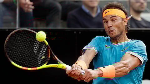 Rafael Nadal of Spain returns the ball to Novak Djokovic of Serbia during their final match at the Italian Open tennis tournament, in Rome, Sunday, May 19, 2019. (AP Photo/Gregorio Borgia)