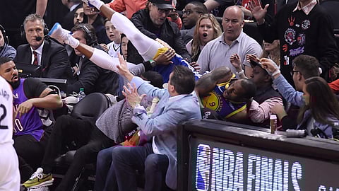 Golden State Warriors guard Andre Iguodala falls into the stands during the first half of Game 1 against the Toronto Raptors in basketball’s NBA Finals, Thursday, May 30, 2019, in Toronto. (Frank Gunn/The Canadian Press via AP)