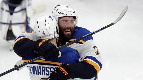 St. Louis Blues’ Carl Gunnarsson (4), of Sweden, is congratulated by Pat Maroon, rear, after he scored the winning goal against the Boston Bruins during the first overtime period in Game 2 of the NHL hockey Stanley Cup Final, Wednesday, May 29, 2019, in Boston. (Bruce Bennett/Pool via AP)