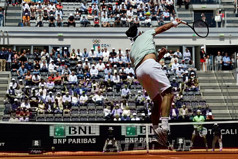 Roger Federer serves the ball during his match against Joao Sousa at the Italian Open tennis tournament, in Rome, Thursday, May, 16, 2019. (AP Photo/Gregorio Borgia)