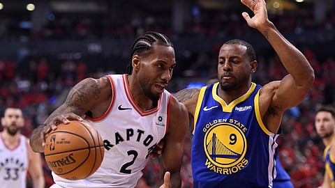 Toronto Raptors forward Kawhi Leonard (2) drives against Golden State Warriors forward Andre Iguodala (9) during second-half basketball action in Game 5 of the NBA Finals in Toronto, Monday, June 10, 2019. (Frank Gunn/The Canadian Press via AP)