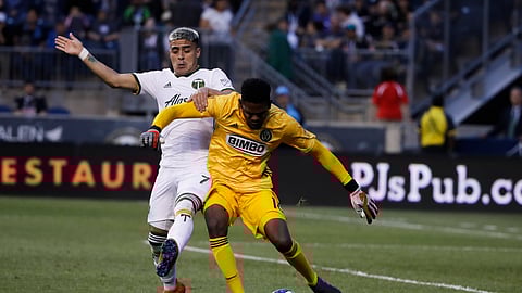 Portland Timbers’ Brian Fernandez, left, and Philadelphia Union goalkeeper Andre Blake battle for the ball during the first half of an MLS soccer match in Chester, Pa., on May 25, 2019. 
