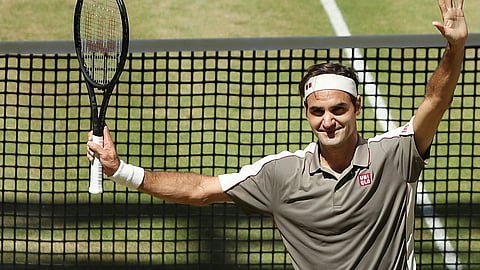 Swiss Roger Federer celebrates after winning the tennis ATP final against Belgium David Goffin in Halle, Germany, Sunday, June 23, 2019. (Friso Gentsch/dpa via AP)  