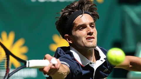 Pierre-Hugues Herbert returns the ball to Gael Monfils during their first round match in Germany on June 17 (Friso Gentsch/dpa)