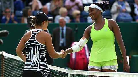 Ashleigh Barty (left) shakes hands with Venus Williams after winning their quarterfinal match of the Nature Valley Classic on June 21 (Nigel French/PA)