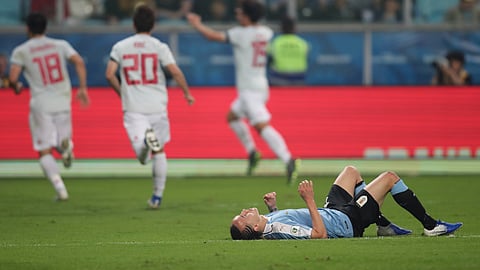 Uruguay’s Diego Laxalt lying on the pitch as Japan players celebrate their side’s first goal during a Copa America Group C soccer match at the Arena Gremio in Porto Alegre, Brazil, Thursday, June 20, 2019. (AP Photo/Edison Vara)