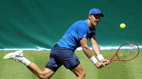 Steve Johnson from United States returns the ball to Germany’s Philipp Kohlschreiber during their first round match at the Noventi Open in Halle Westphalia, Germany, Monday, June 17, 2019. (Friso Gentsch/dpa via AP)