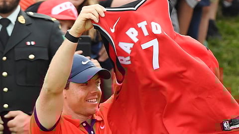 Rory McIlroy raises a Kyle Lowry No. 7 Toronto Raptors jersey after winning the Canadian Open on June 9 (Nathan Denette/The Canadian Press)