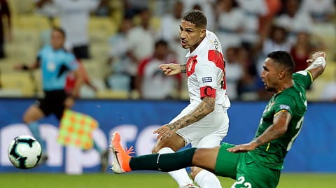 Peru’s Paolo Guerrero, left, strike the ball past Bolivia’s Adrian Jusino, to score his team’s equalizer during a Copa America Group A soccer match at Maracana stadium in Rio de Janeiro, Brazil, Tuesday, June 18, 2019. (AP Photo/Silvia Izquierdo)