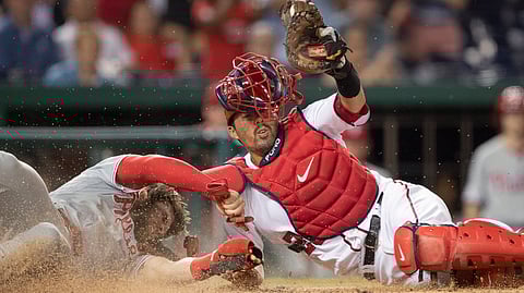 When he isn’t hitting home runs against the Phillies this season, Nationals catcher Kurt Suzuki is tagging them out at home plate, erasing Bryce Harper on June 20 (Manuel Balce Ceneta)