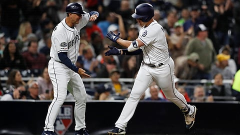 Padres’ Hunter Renfroe (right) is greeted by third base coach Glenn Hoffman after hitting a two-run home run in the second inning on June 6 (Gregory Bull)