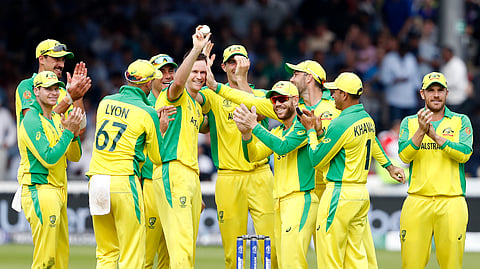 Australia’s Jason Behrendorff, centre, holds up the ball as he celebrates with teammates after taking the wicket of England’s Jofra Archer during the Cricket World Cup match between England and Australia at Lord’s cricket ground in London, Tuesday, June 25, 2019. (AP Photo/Alastair Grant)