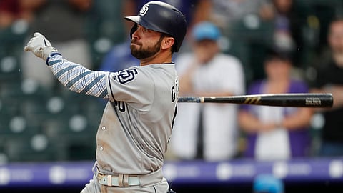 Padres’ Greg Garcia triples in the 90th and 91st runs of the Padres-Rockies series on June 16 (David Zalubowski)