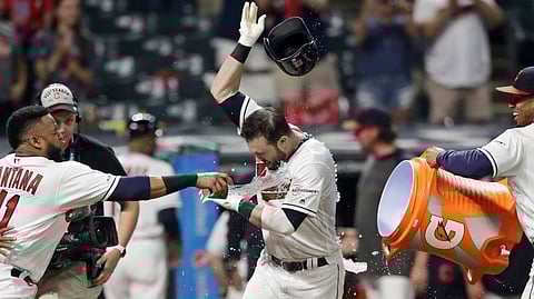 Cleveland Indians’ Jason Kipnis (center) is doused with water from after his game-winning solo home run on June 24 (Tony Dejak)