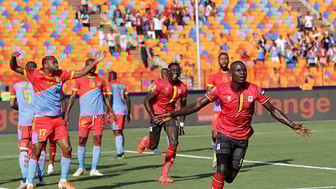 Uganda’s Patrick Henry Kaddu, center, celebrates after he scored first goal during the African Cup of Nations group A soccer match between DR Congo and Uganda at Cairo International Stadium in Cairo, Egypt, Saturday, June 22, 2019. (AP Photo/Hassan Ammar)