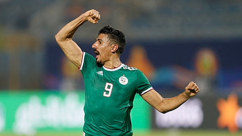 Algeria’s Baghdad Bounedjah celebrates at the end of the African Cup of Nations group C soccer match between Algeria and Senegal at 30 June Stadium in Cairo, Egypt, Thursday, June 27, 2019. (AP Photo/Ariel Schalit)