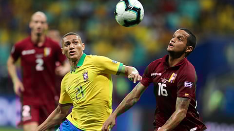 Brazil’s Richarlison, left, vies for the ball with Venezuela’s Roberto Rosales during a Copa America Group A soccer match at the Arena Fonte Nova in Salvador, Brazil, Tuesday, June 18, 2019. (AP Photo/Natacha Pisarenko)