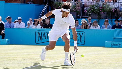 Feliciano Lopez returns the ball to Felix Auger-Aliassime during their men’s singles semifinal match on June 22 (Alastair Grant)
