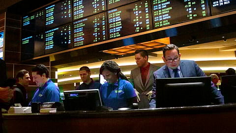 This Oct. 25, 2018 photo shows employees at the new sports book at the Tropicana casino in Atlantic City N.J., preparing to take bets moments before it opened.
