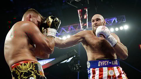 Tyson Fury, of England, hits Tom Schwarz, of Germany, during a heavyweight boxing match Saturday, June 15, 2019, in Las Vegas. (AP Photo/John Locher)