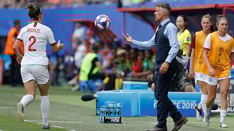 England head coach Philip Neville passes the ball to England’s Lucy Bronze during the Women’s World Cup Round of 16 soccer match against Cameroon on June 23 (Michel Spingler)