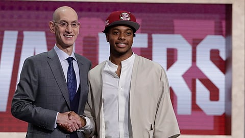 Darius Garland poses for photographs with NBA Commissioner Adam Silver after being selected with the fifth pick on June 20 (Julio Cortez)