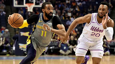 FILE - In this March 23, 2019, file photo, Memphis Grizzlies guard Mike Conley (11) handles the ball against Minnesota Timberwolves guard Josh Okogie (20) in the first half of an NBA basketball game, in Memphis, Tenn. (AP Photo/Brandon Dill, File)