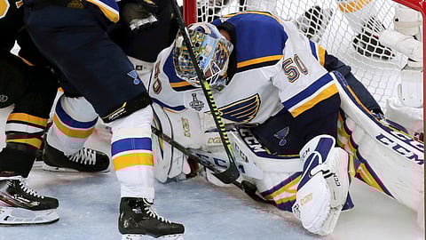 Blues goaltender Jordan Binnington stops a shot at the goal line as Boston Bruins’ David Krejci pokes at it in Game 5 on June 6 (Charles Krupa)
