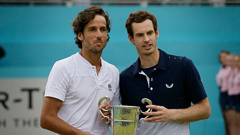 Andy Murray of Britain, left, celebrates with Feliciano Lopez of Spain after winning their men’s doubles final tennis match against Joe Salisbury of Britain and the Rajeev Ram of the United States at the Queens Club tennis tournament in London, Sunday June 23, 2019. (AP Photo/Tim Ireland)