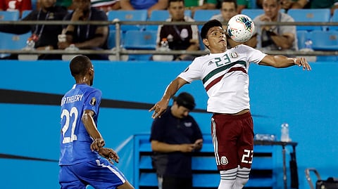 Mexico’s Jesus Gallardo (23) moves the ball against Martinique’s Romario Barthelery (22) during the first half of their CONCACAF Golf Cup soccer match in Charlotte, N.C., Sunday, June 23, 2019. (AP Photo/Chuck Burton) 
