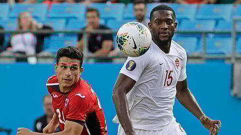 Canada’s Doneil Henry (15) and Cuba’s Luis Paradela (23) chase the ball during the first half of a CONCACAF Golf Cup soccer match in Charlotte, N.C., Sunday, June 23, 2019. (AP Photo/Chuck Burton)