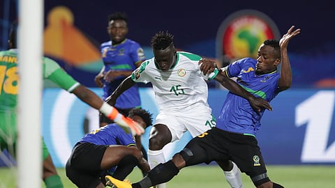 Senegal’s Krepin Diatta, left, and Senegal’s Idrissa Gana Gueye fight for the ball during the African Cup of Nations group C soccer match between Senegal and Tanzania at 30 June Stadium in Cairo, Egypt, Sunday, June 23, 2019. (AP Photo/Hassan Ammar)