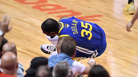 Golden State Warriors forward Kevin Durant (35) goes down with a leg injury against the Toronto Raptors during first half action in Game 5 of the NBA Finals in Toronto on Monday, June 10, 2019. (Frank Gunn/The Canadian Press via AP)