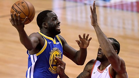 Golden State Warriors forward Draymond Green (23) drives to the net under pressure from Toronto Raptors forward Kawhi Leonard (2) during the first half of Game 2 of basketball’s NBA Finals, Sunday, June 2, 2019, in Toronto. (Frank Gunn/The Canadian Press via AP)